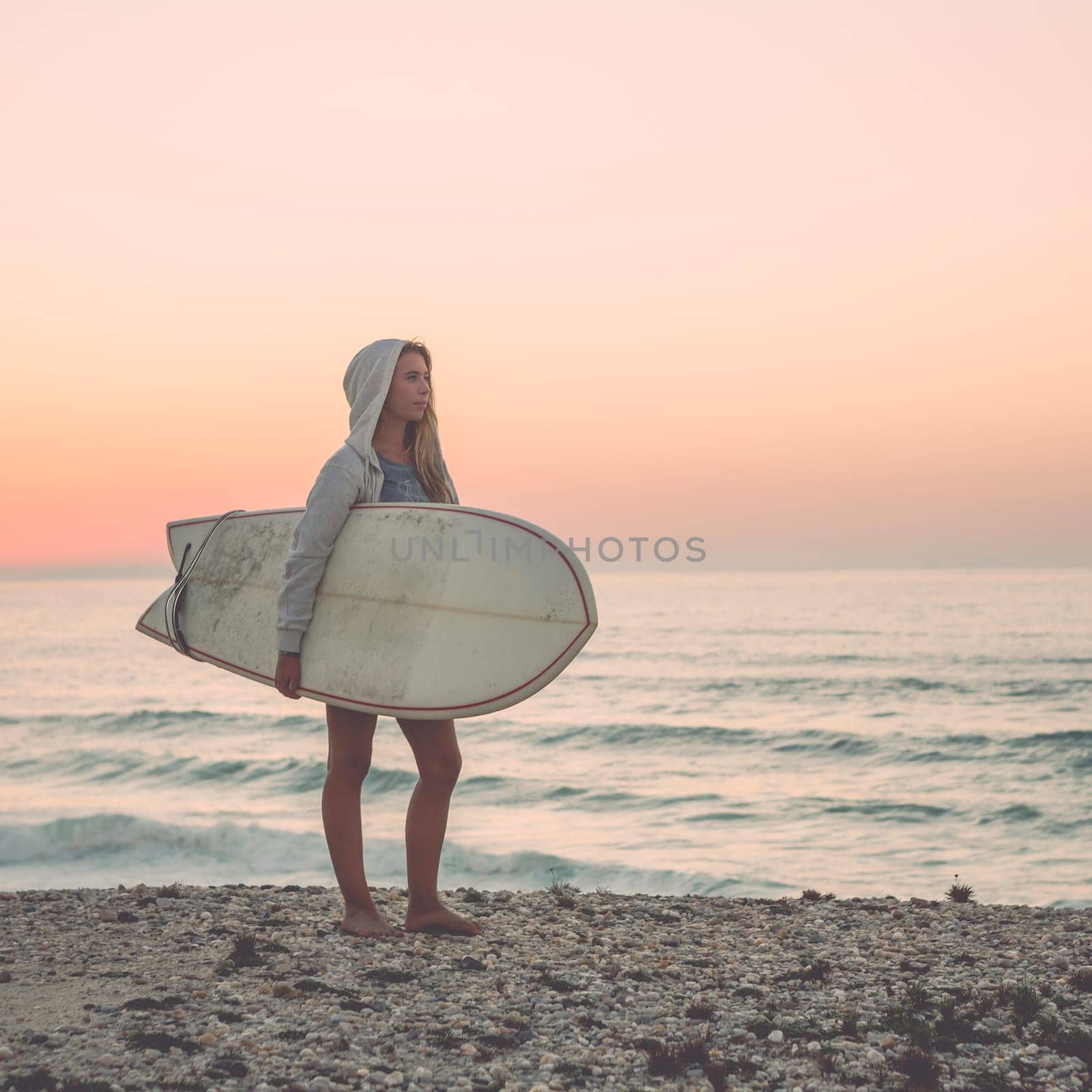 A beautiful girl at the beach with her bodyboard