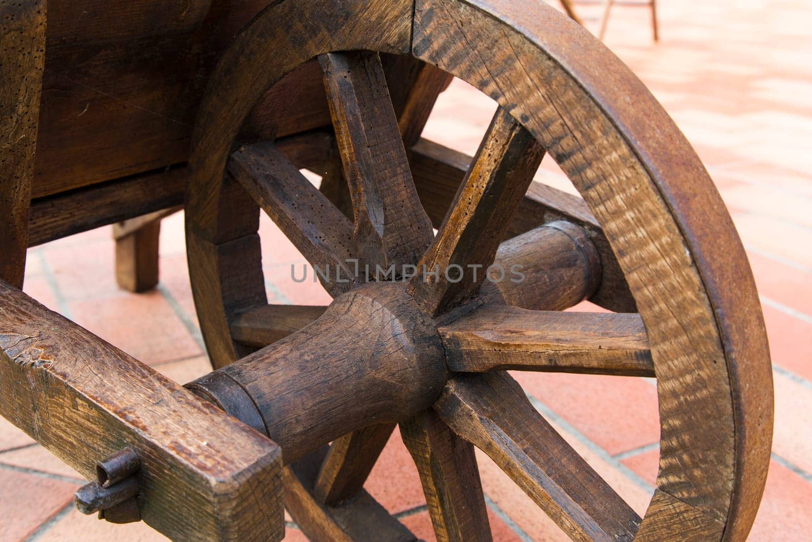 View of a wooden wheel of an ancient wheelbarrow