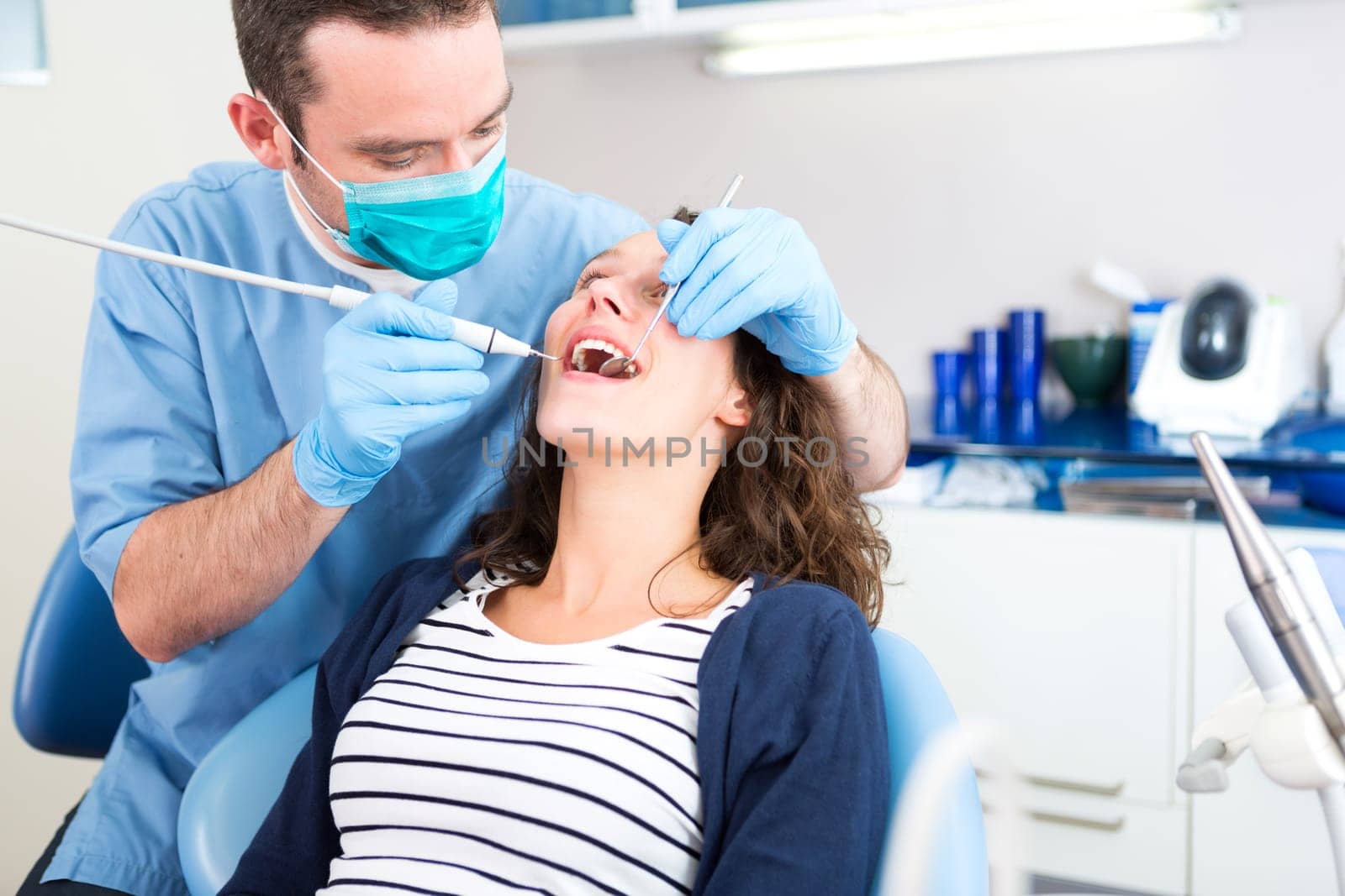 View of a Young attractive woman being cured by a dentist