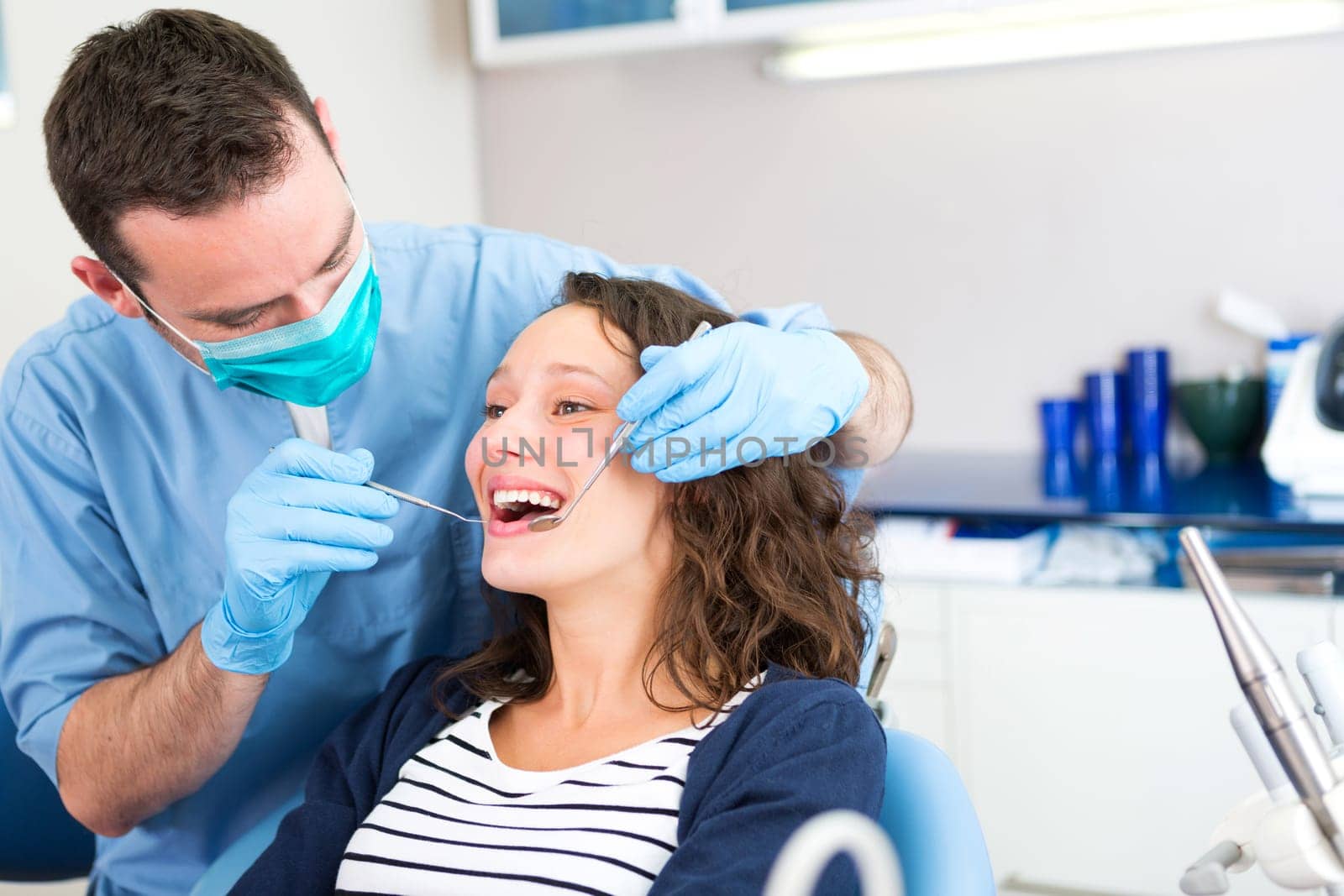 View of a Young attractive woman being cured by a dentist