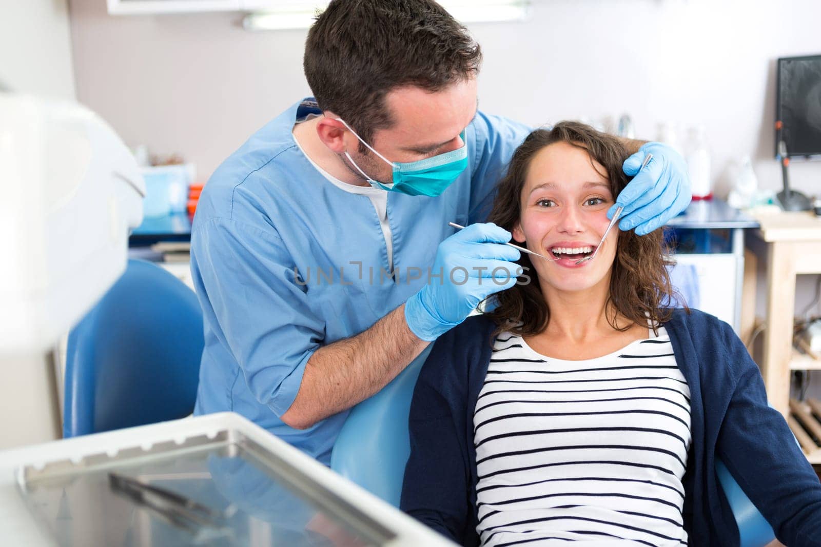 View of a Young attractive woman being cured by a dentist