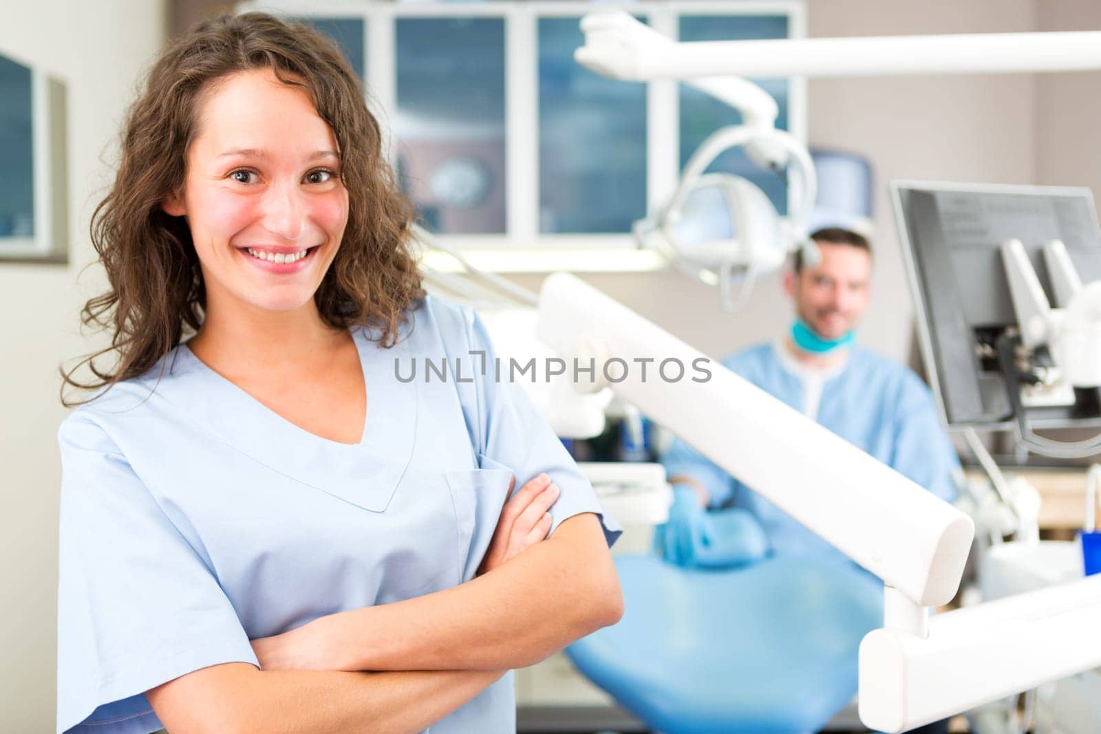 View of a young attractive dentist in his office