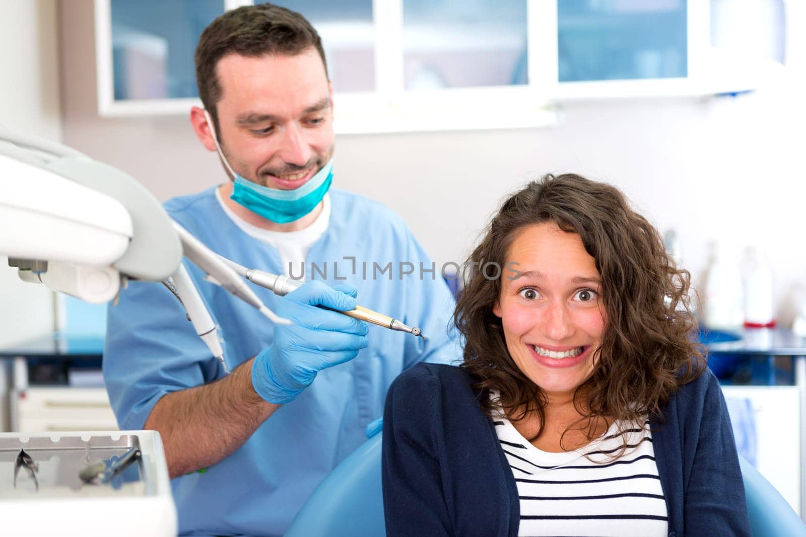 View of a Young attractive woman being cured by a dentist