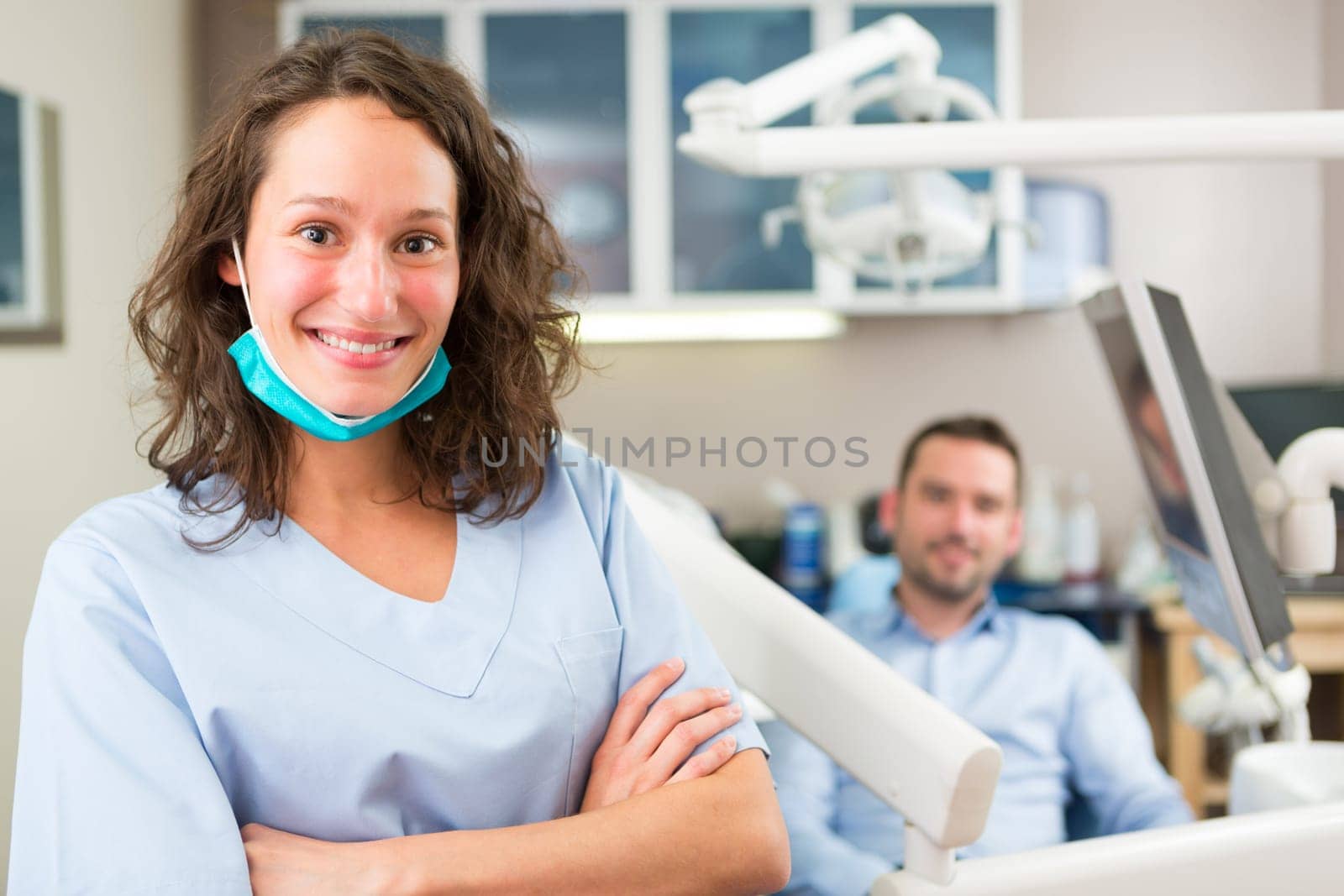 View of a young attractive dentist in his office