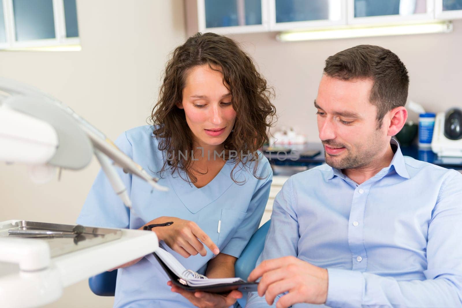 View of a Young attractive dentist programs next date