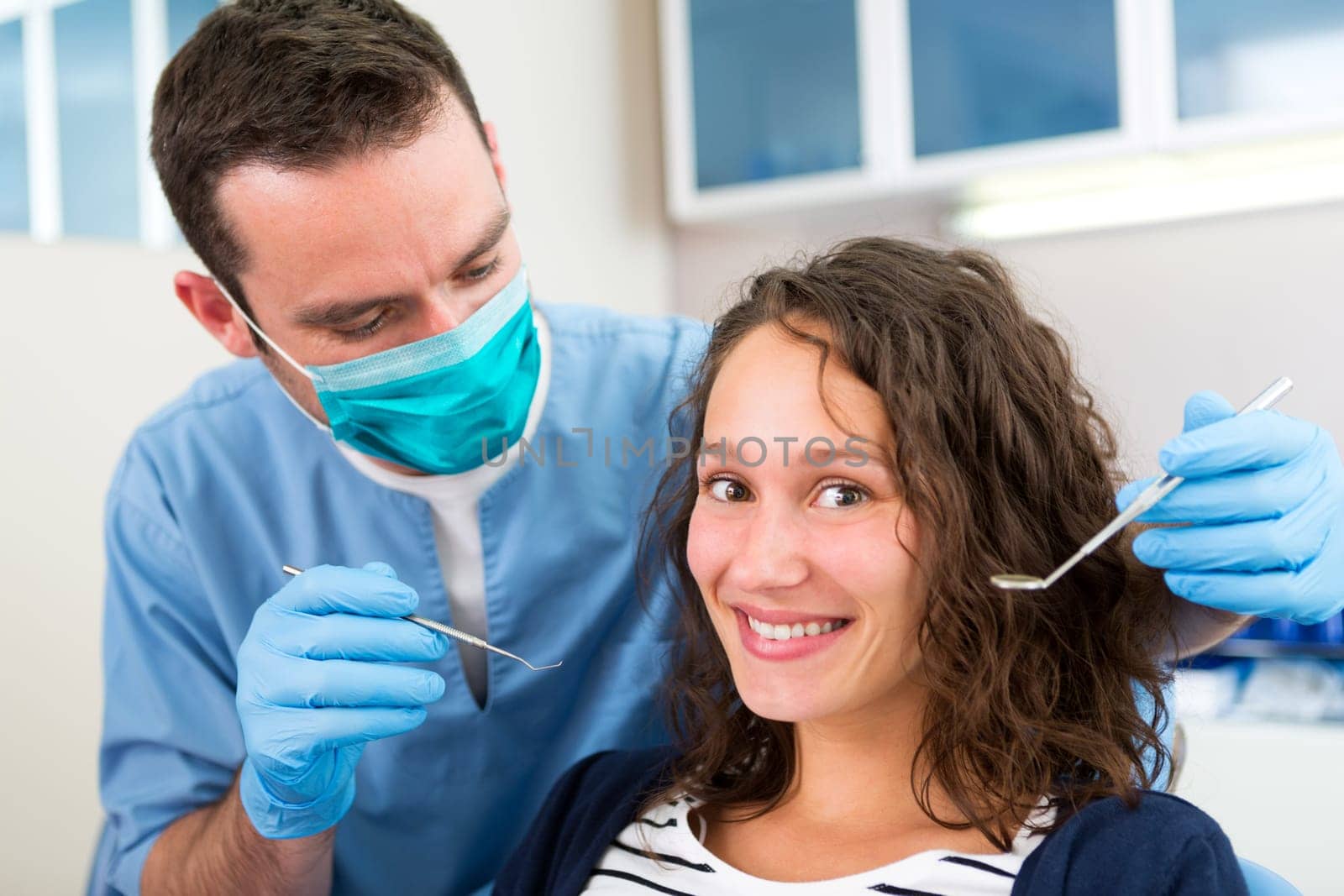 View of a Young attractive woman being cured by a dentist