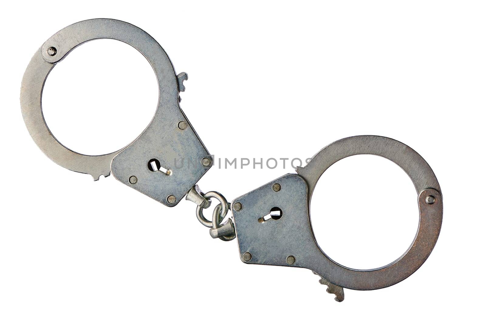 Metal handcuffs on a white isolated background, copy space. High quality photo