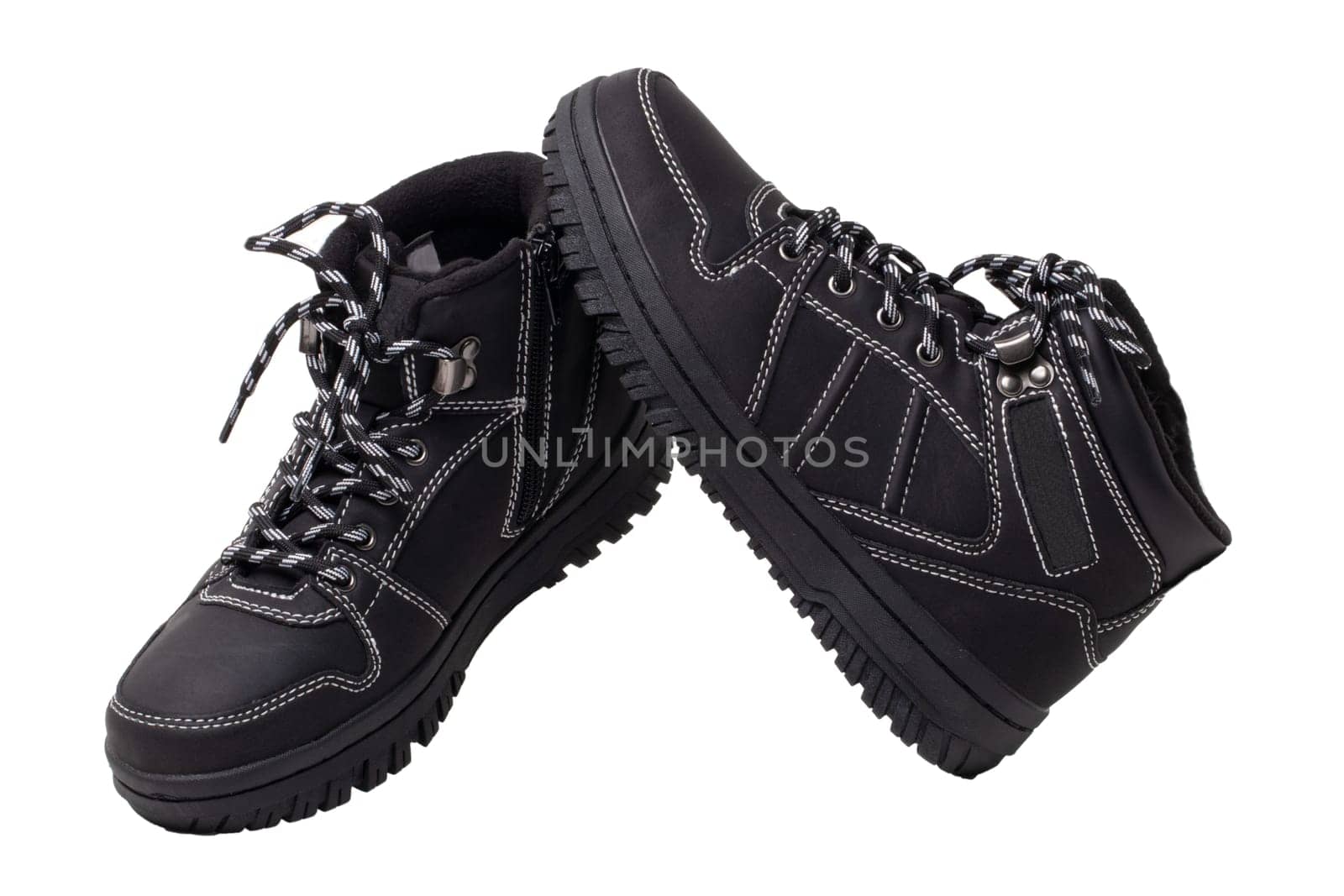 Winter boots. Close-up of a pair elegant black leather winter boots with laces and rivets isolated on white. Clipping path. Macro. Autumn shoe fashion for child boy.