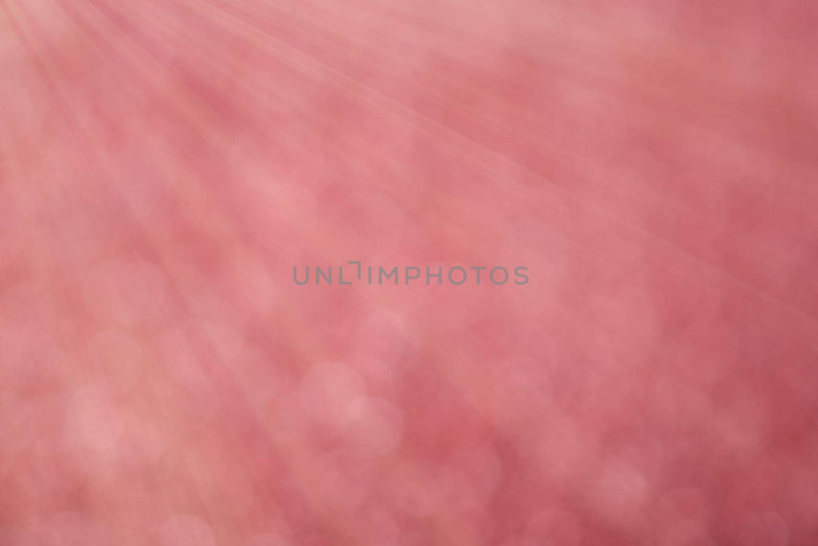 Red bokeh background with defocused round lights and sunbeams, flare overlay