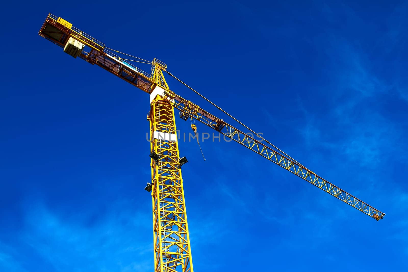 Construction crane against a blue sky.