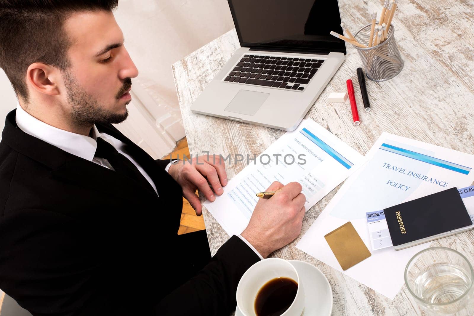 Travel insurance application form with a boarding pass and a passport.