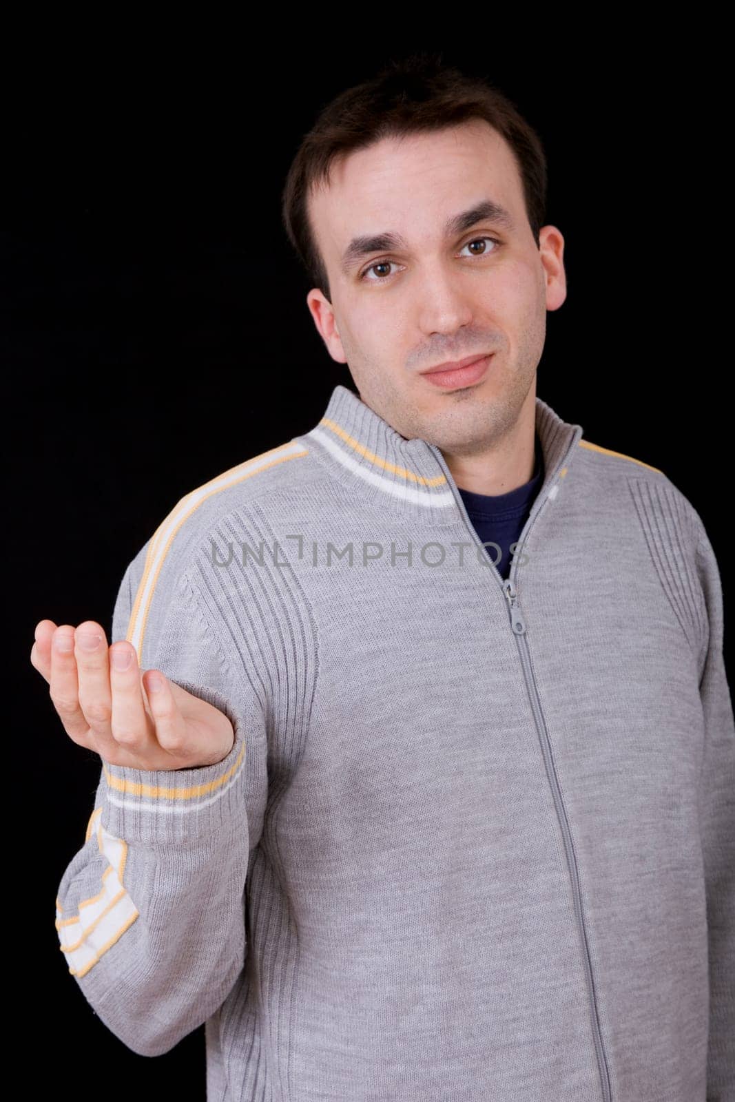 young casual man thinking on black background