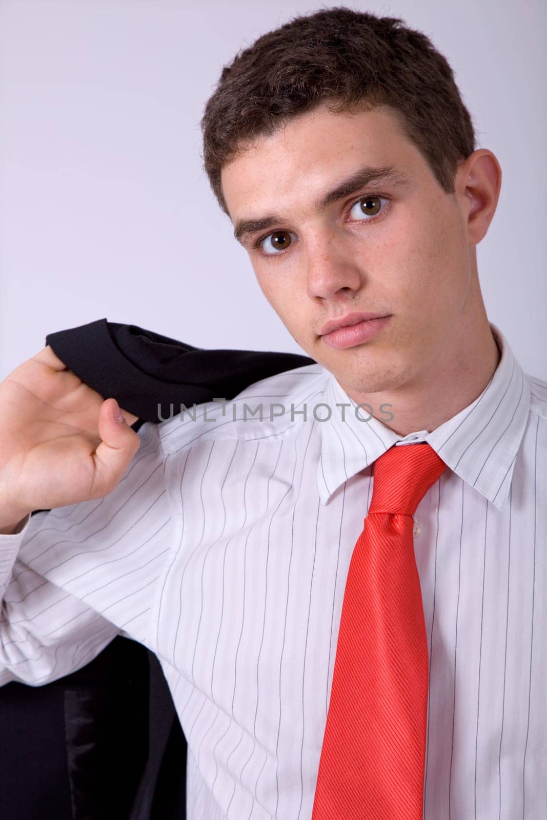 young business man pensive, on a grey background