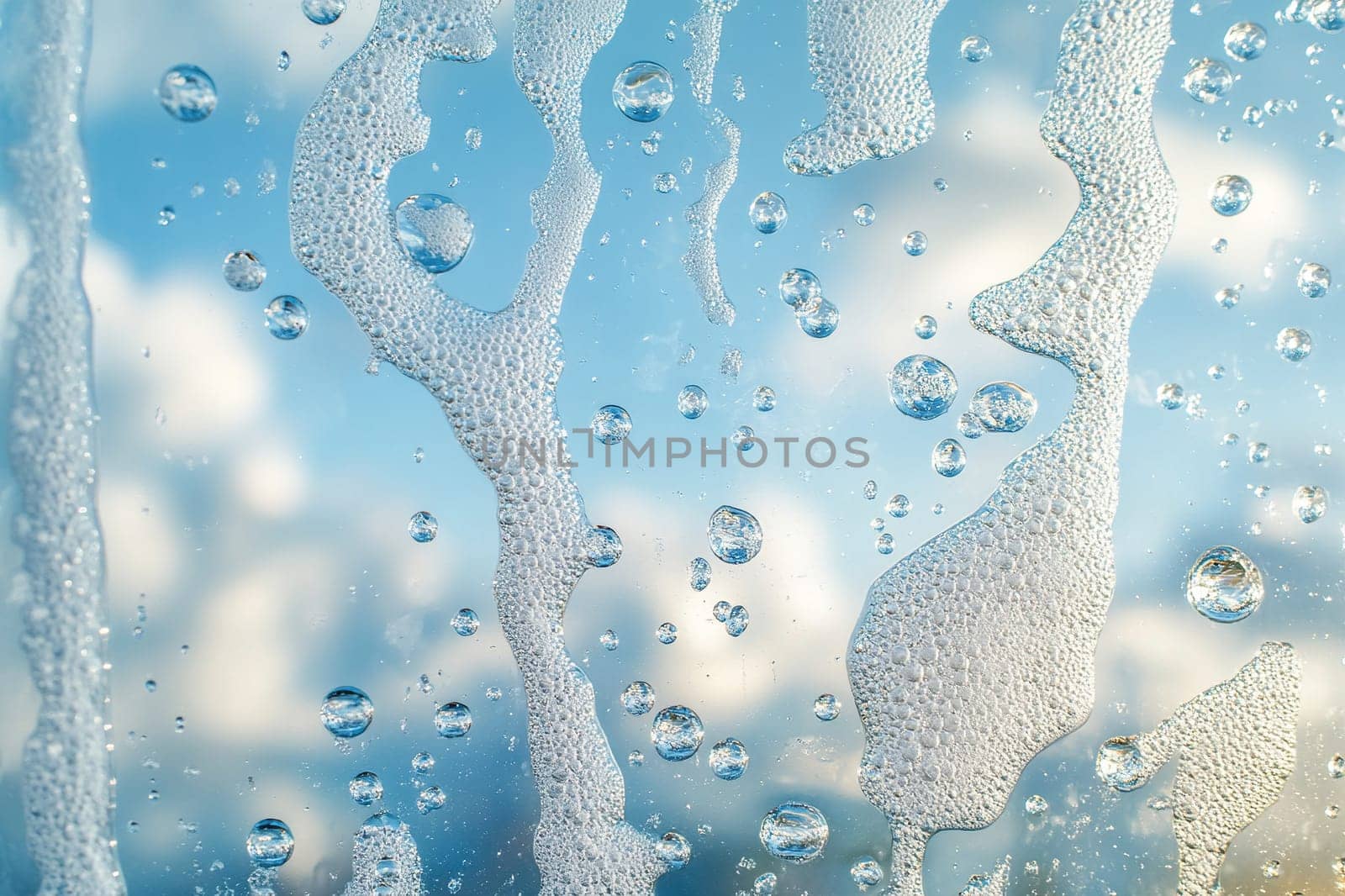Window in soap foam. Clean strip on foamy glass, window washing in spring sunny day