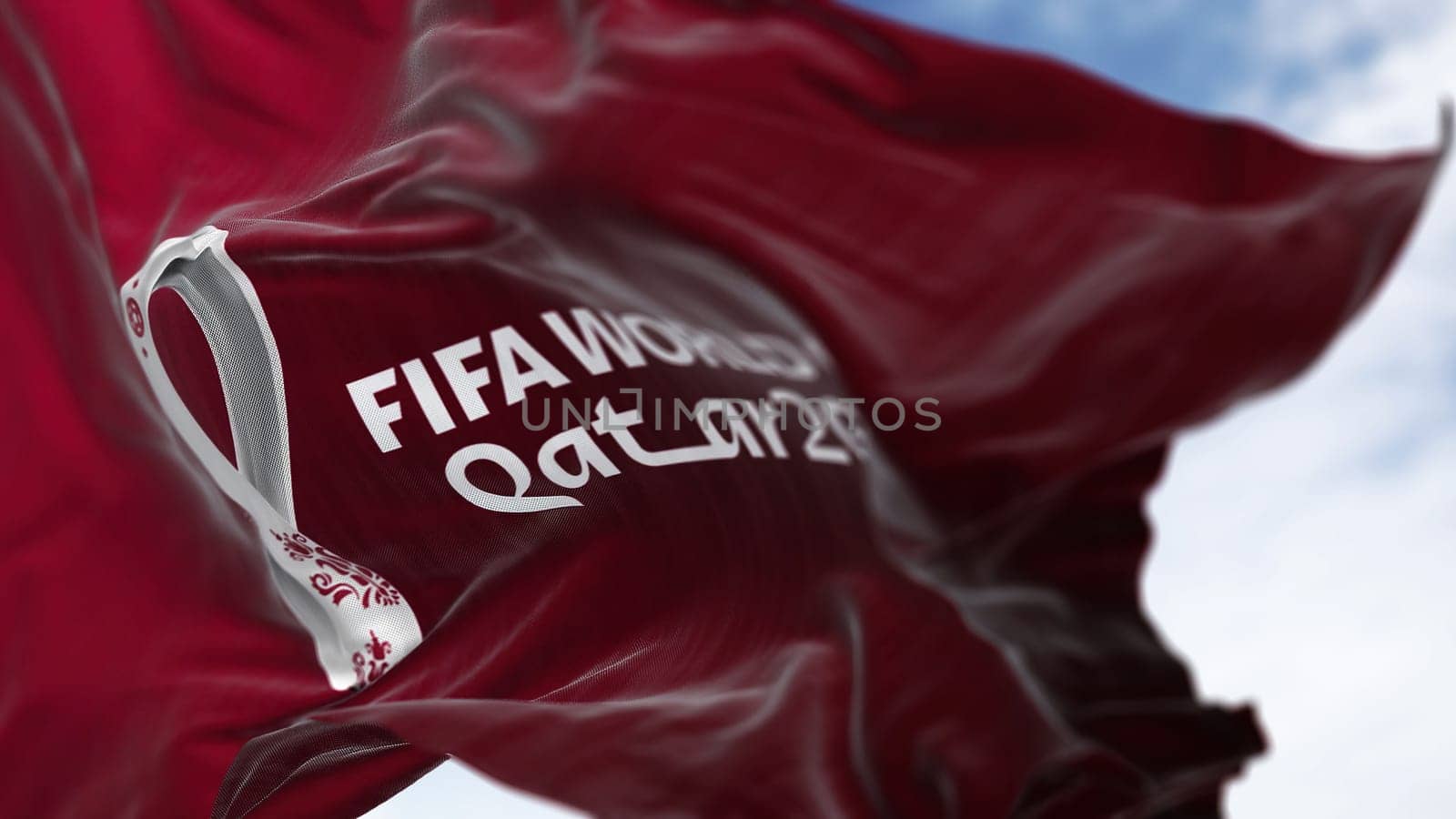 Doha, QA, October 2022. Close-up view of the FIFA Qatar 2022 World Cup flag waving in the wind. The World Cup will take place in Qatar from 20 November to 18 December 2022