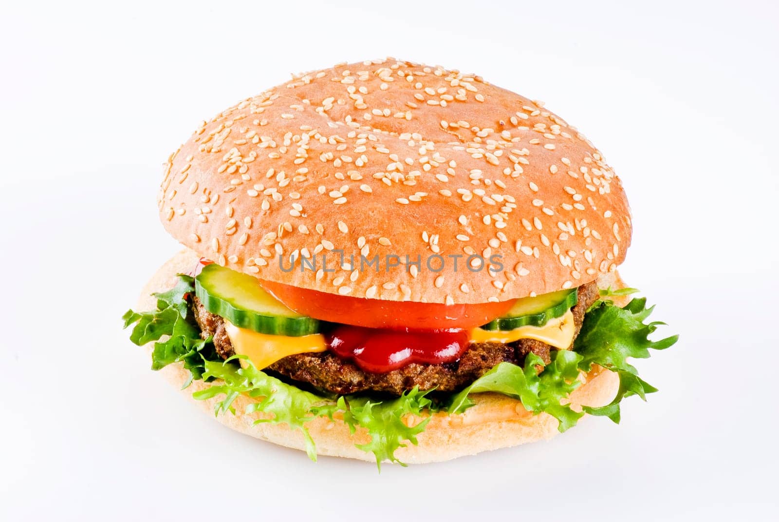 Beefburger in sesame seed bun with vegetables isolated