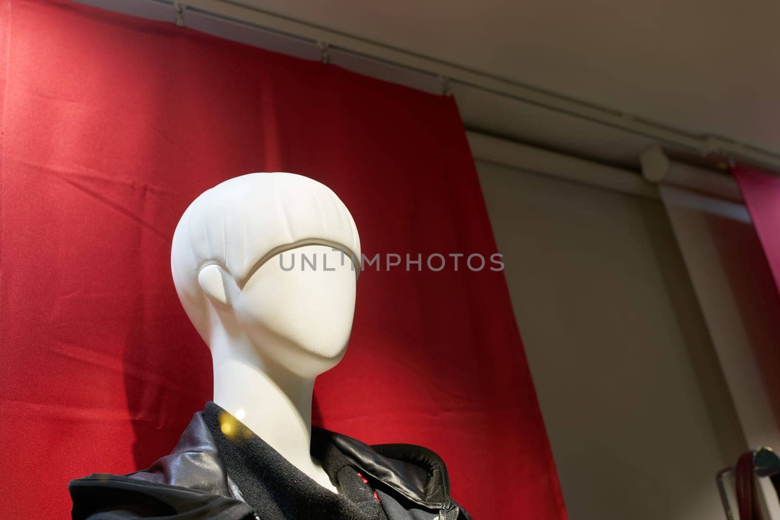Head of a female mannequin against red background in a shop window in Colmar in France