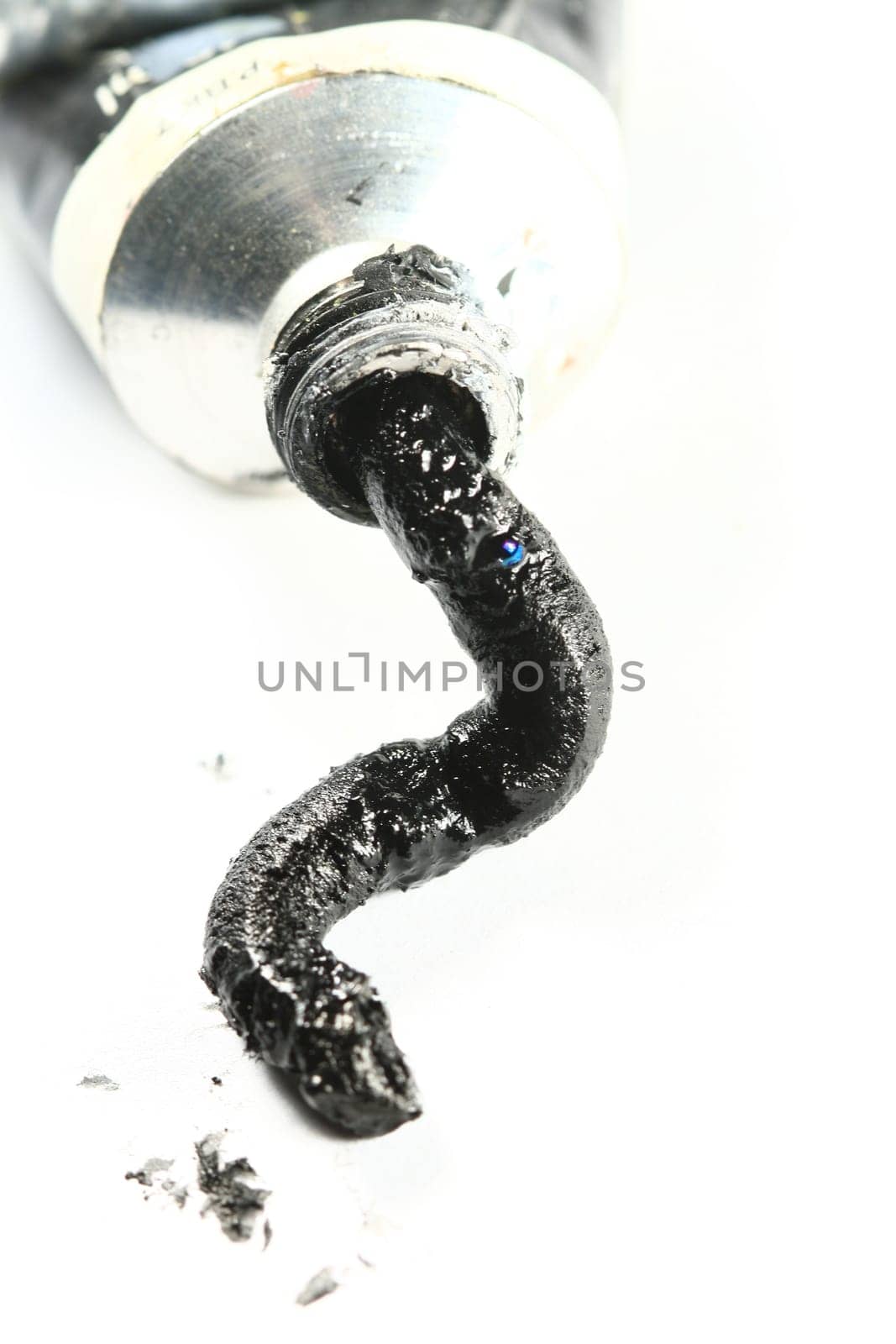 black paint in tube on white paper