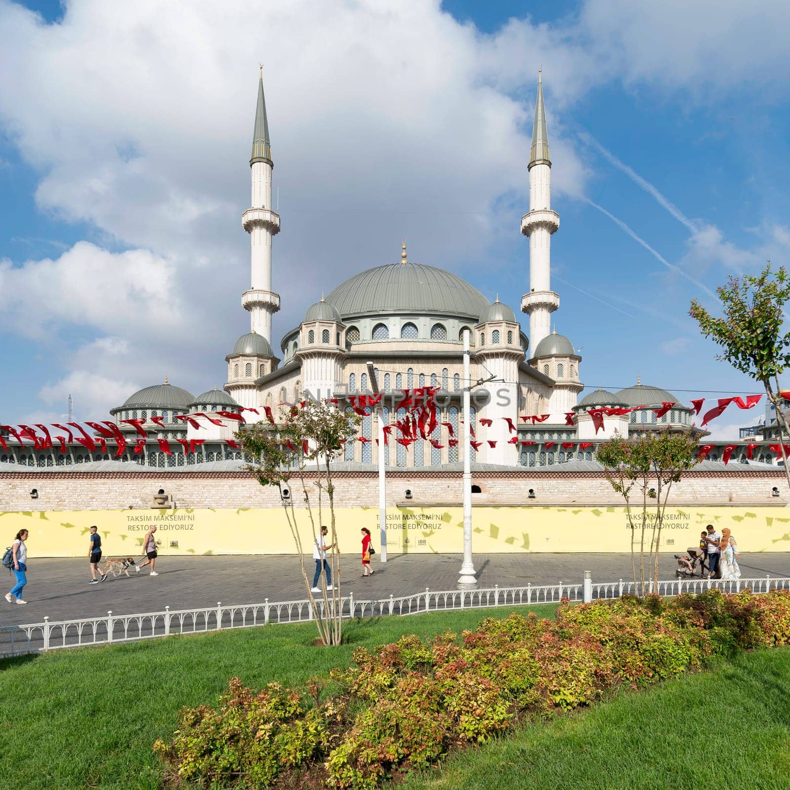Istanbul, Turkey - September 2 2022: Tourists and locals walking in front of Taksim Mosque, at Taksim Square, Beyoglu district, central Istanbul, in a sunny summer day