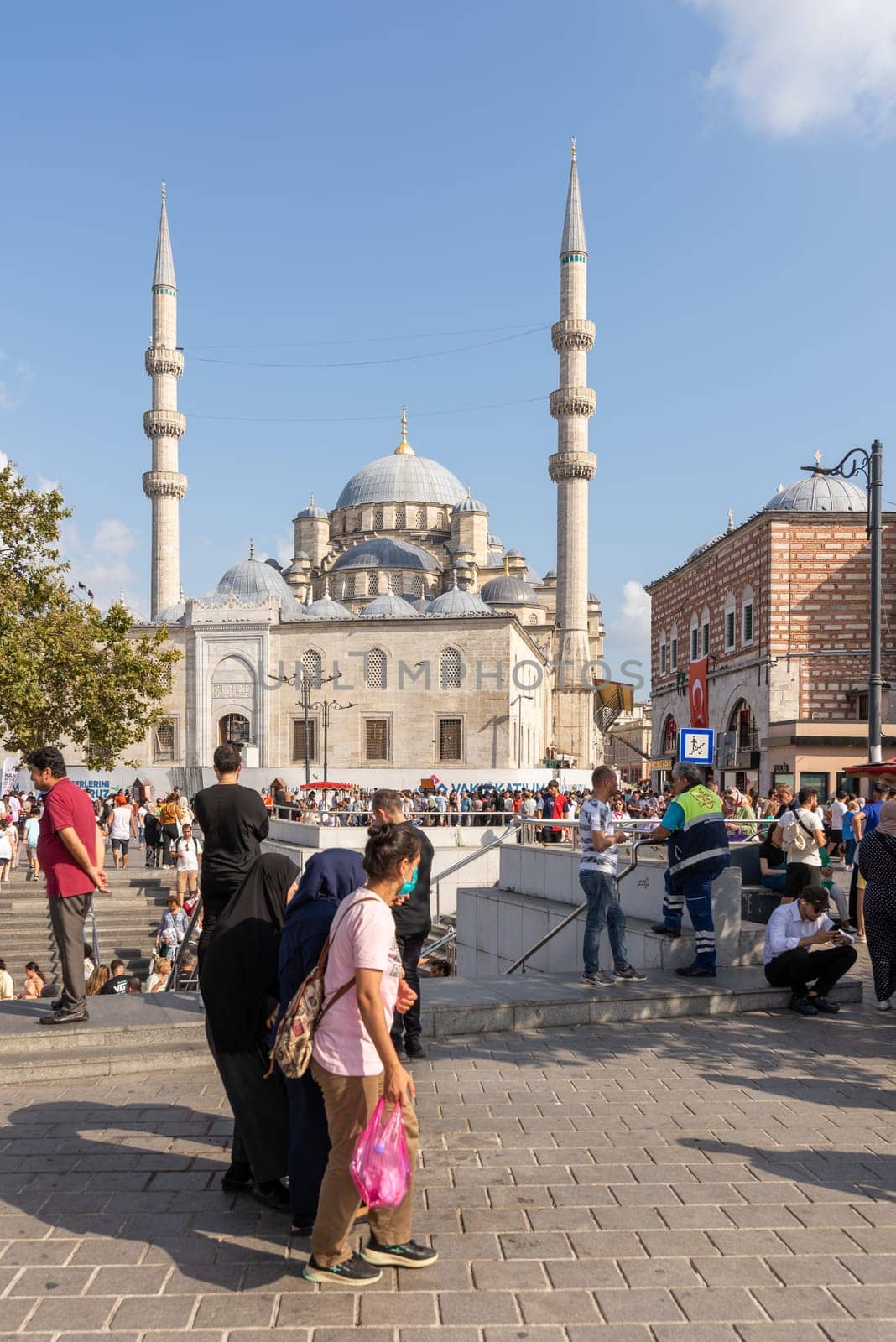 Istanbul, Turkey - August 30, 2022: Crowds of citizens at Eminonu during the Victory Day holiday with the New Mosque, or Yeni Camii in the background