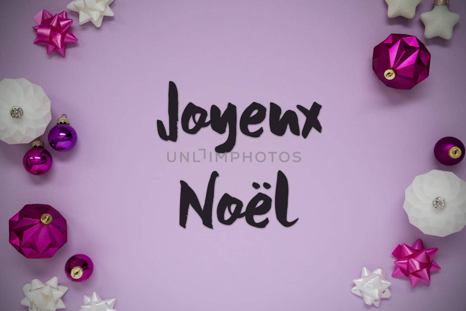 Christmas Card With French Text Joyeux Noel Means Merry Christmas. Purple Christmas Background With Romantic And Brilliant Decoration Like Balls.