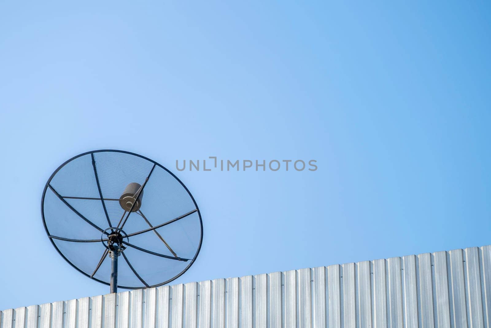 Old satellite dish on the blue sky background