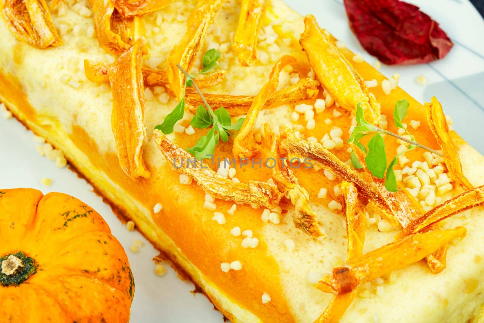 Homemade cakes, autumn recipe. Cottage cheese pumpkin casserole decorated with orange peels.