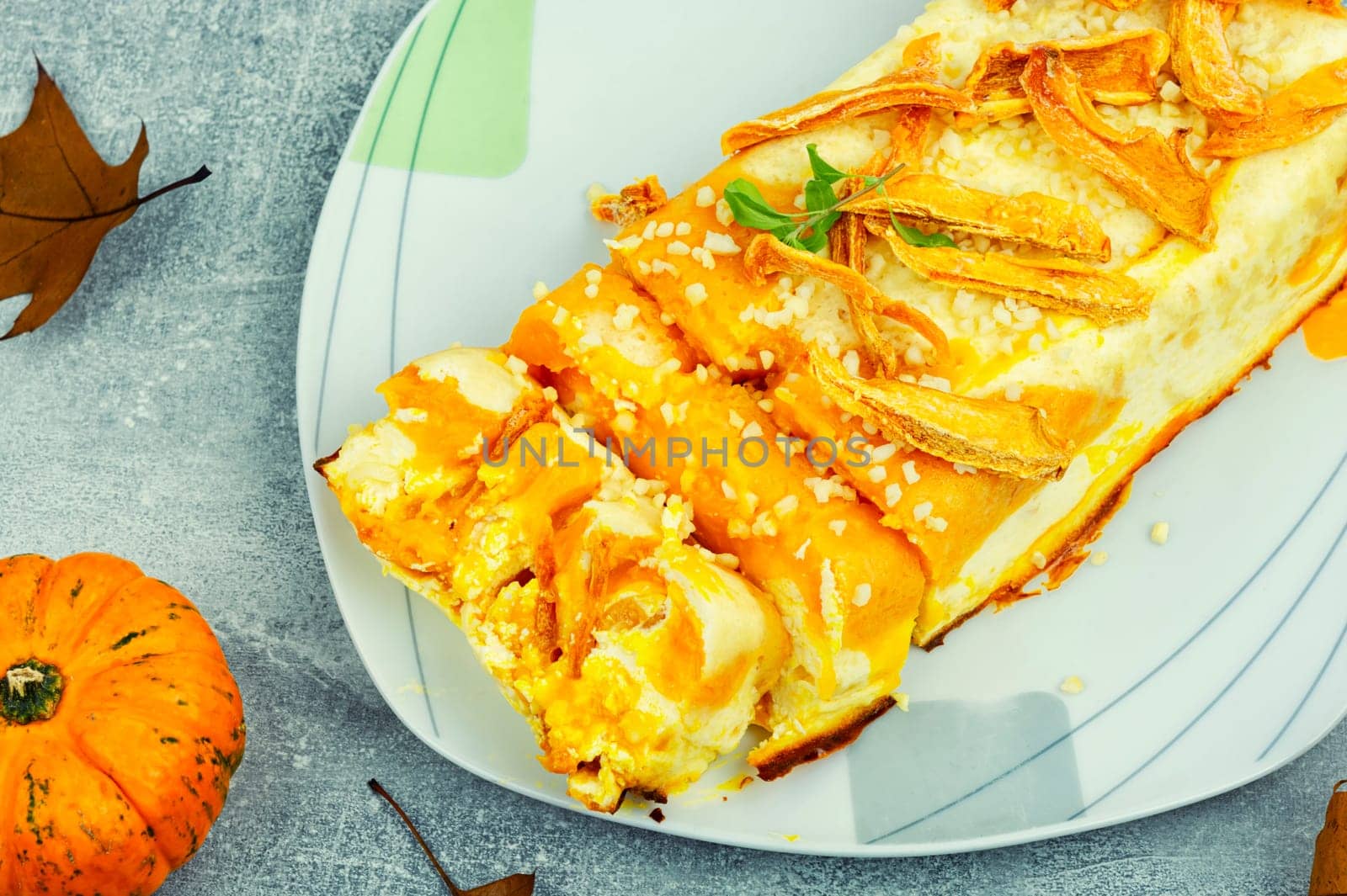 Homemade cakes, autumn recipe. Cottage cheese pumpkin casserole decorated with orange peels.