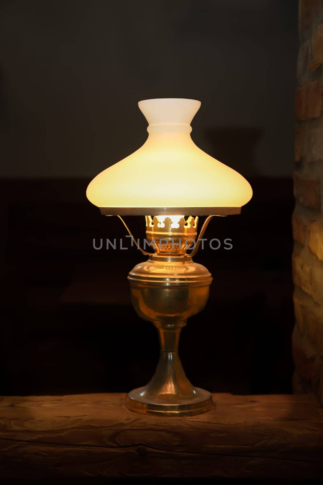 A floor lamp on a base made of a wooden post.