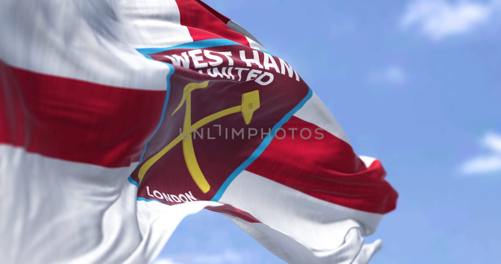London, UK, Oct. 2022: The flag of West Ham United F.C. waving in the wind. West Ham United F.C is an English football club based in London. Selective focus. 3D illustration