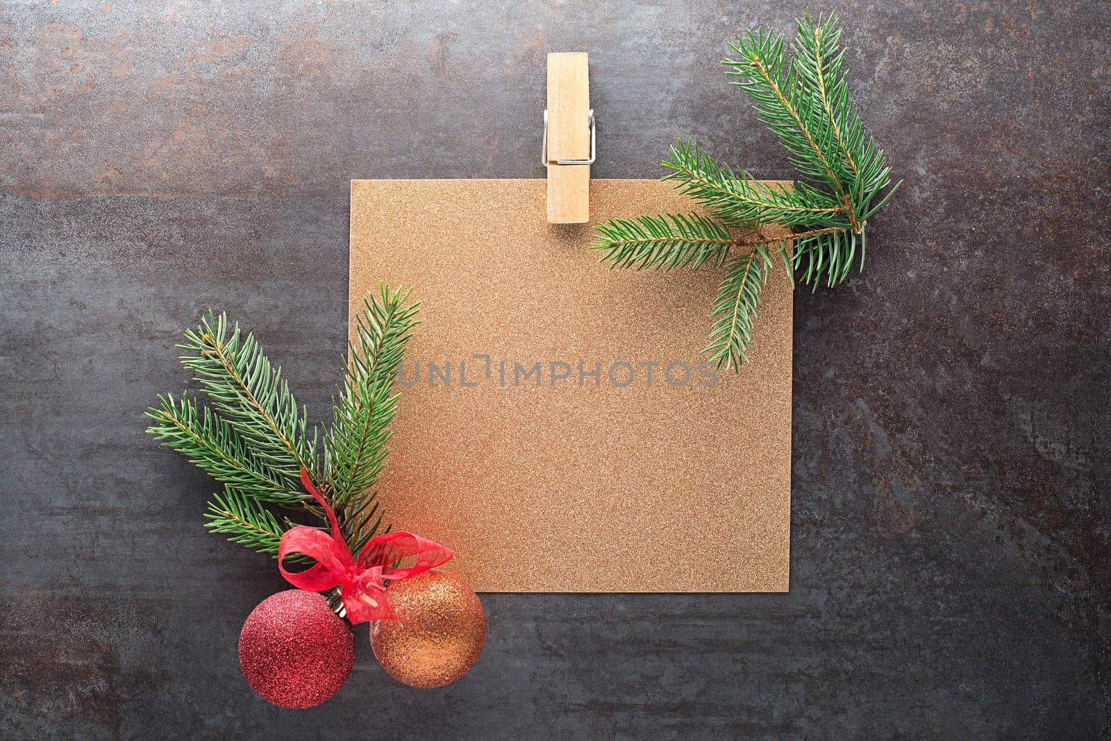 Christmas tree branches with paper card note. Flat lay. Nature New Year concept.