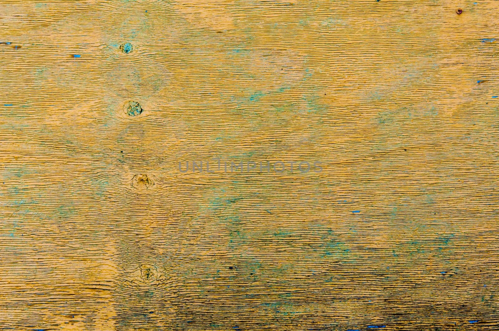 Weathered yellow wood with peeling paint