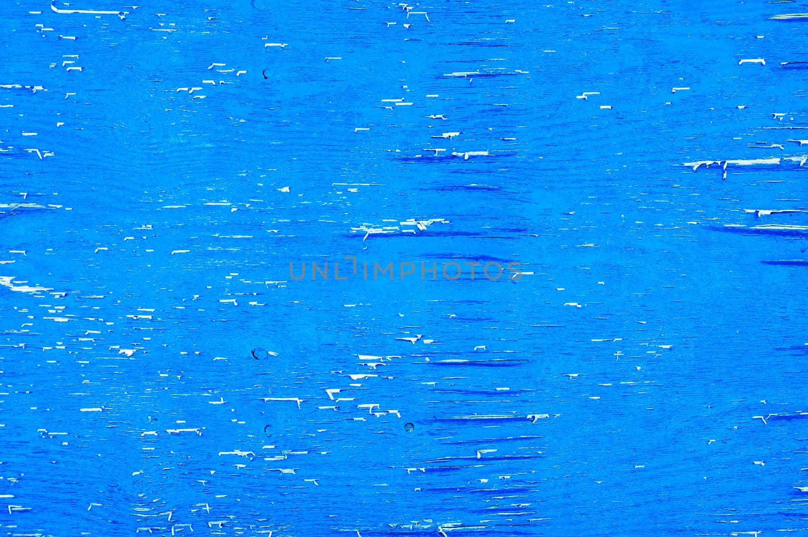 Weathered blue wood with peeling paint