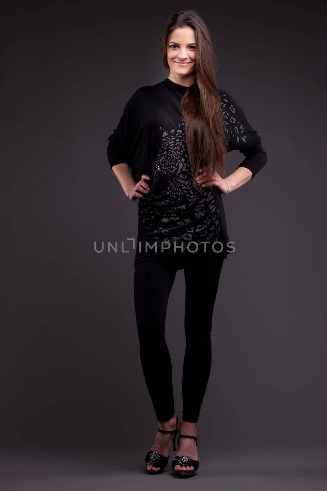 A long-haired beautiful self-confident woman posing