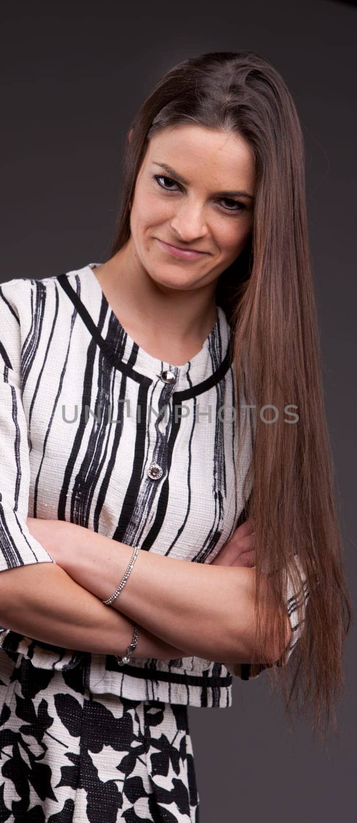 A long-haired beautiful self-confident woman posing