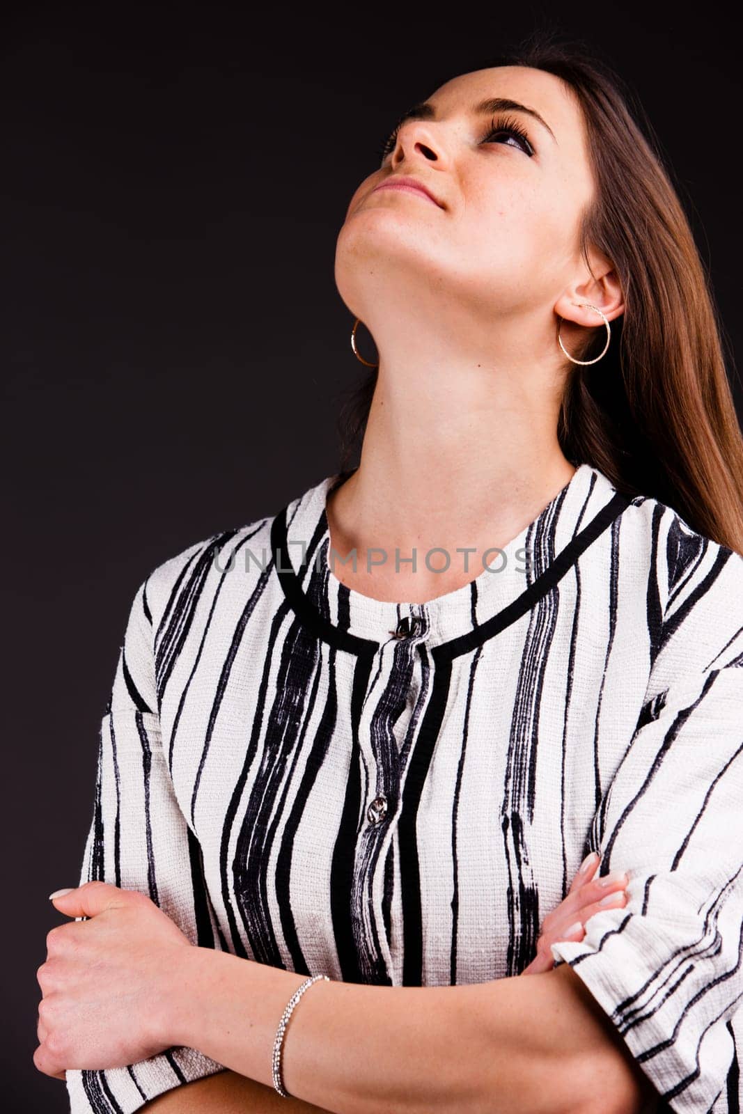 A long-haired beautiful self-confident woman posing