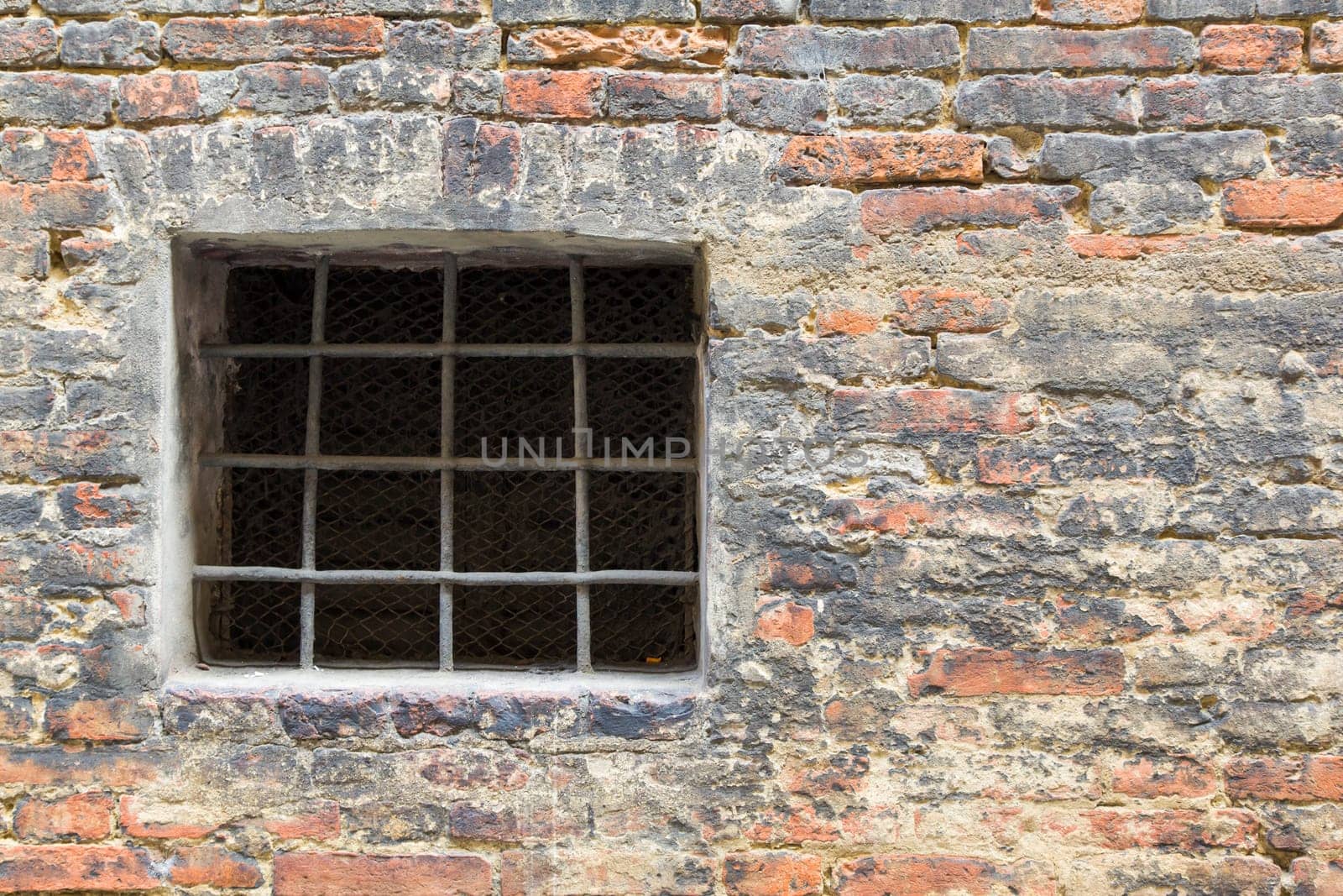 View of a detail of an ancient wall with grate