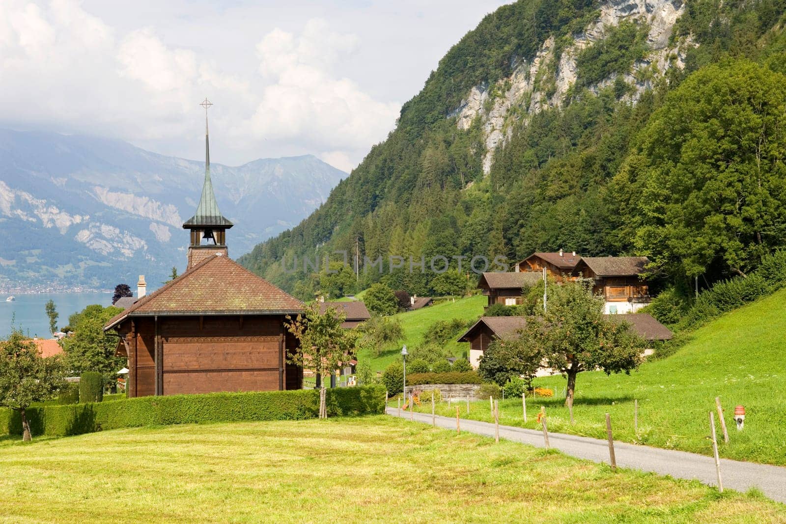 View of wooden church with a lake and mountain at switzerland