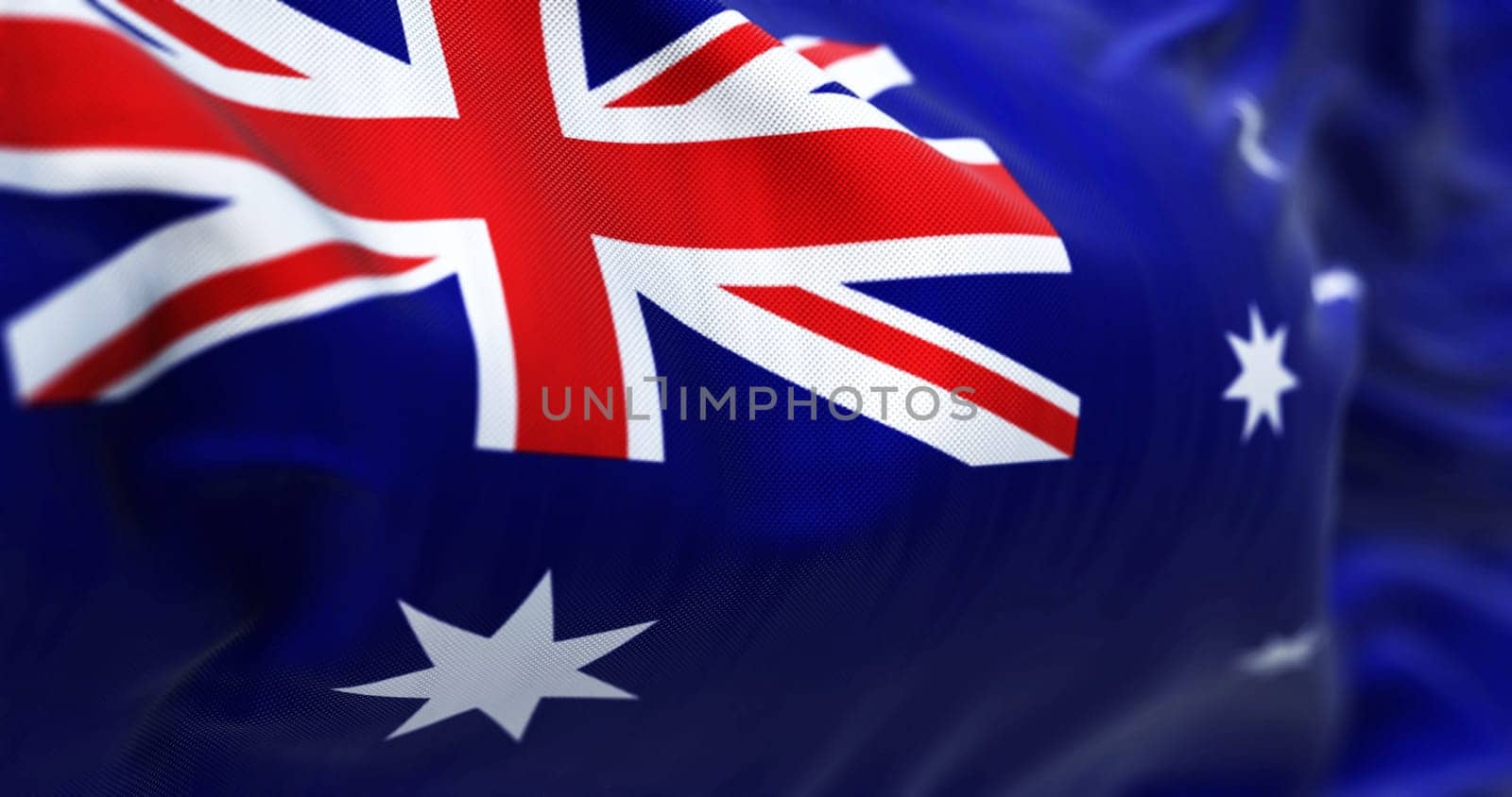 Close-up view of the Australia national flag waving. The Commonwealth of Australia is a state located in Oceania. Fabric textured background. Selective focus. 3D illustration