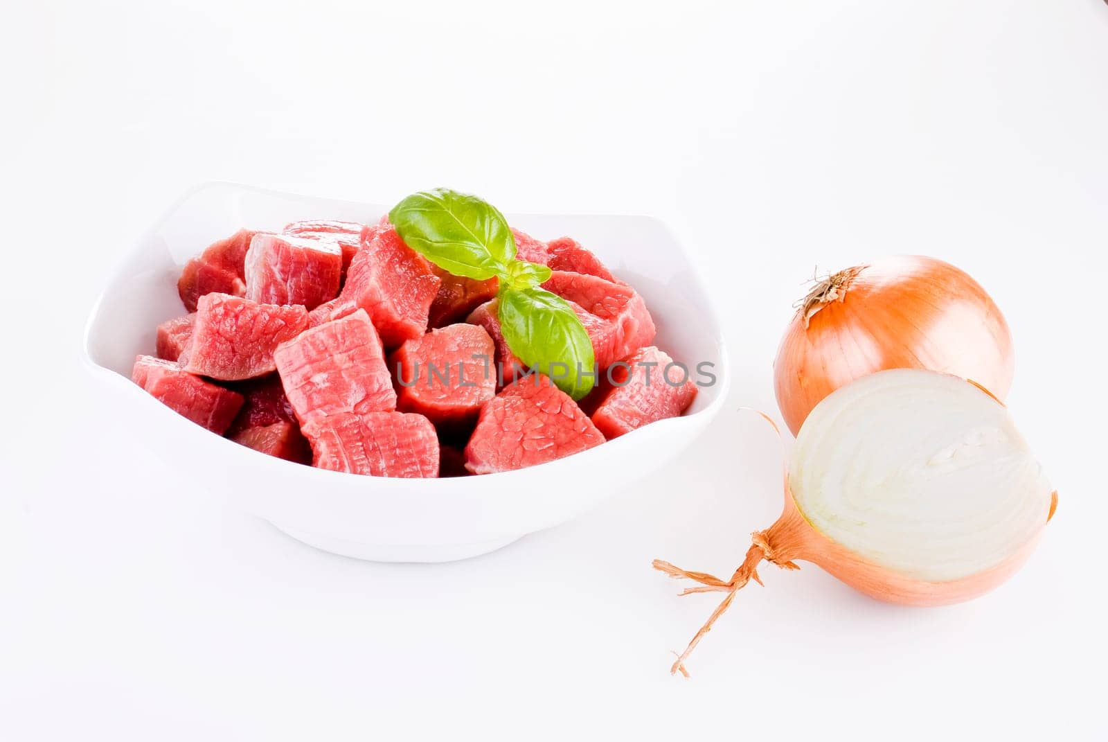 Diced beef with onion over white background