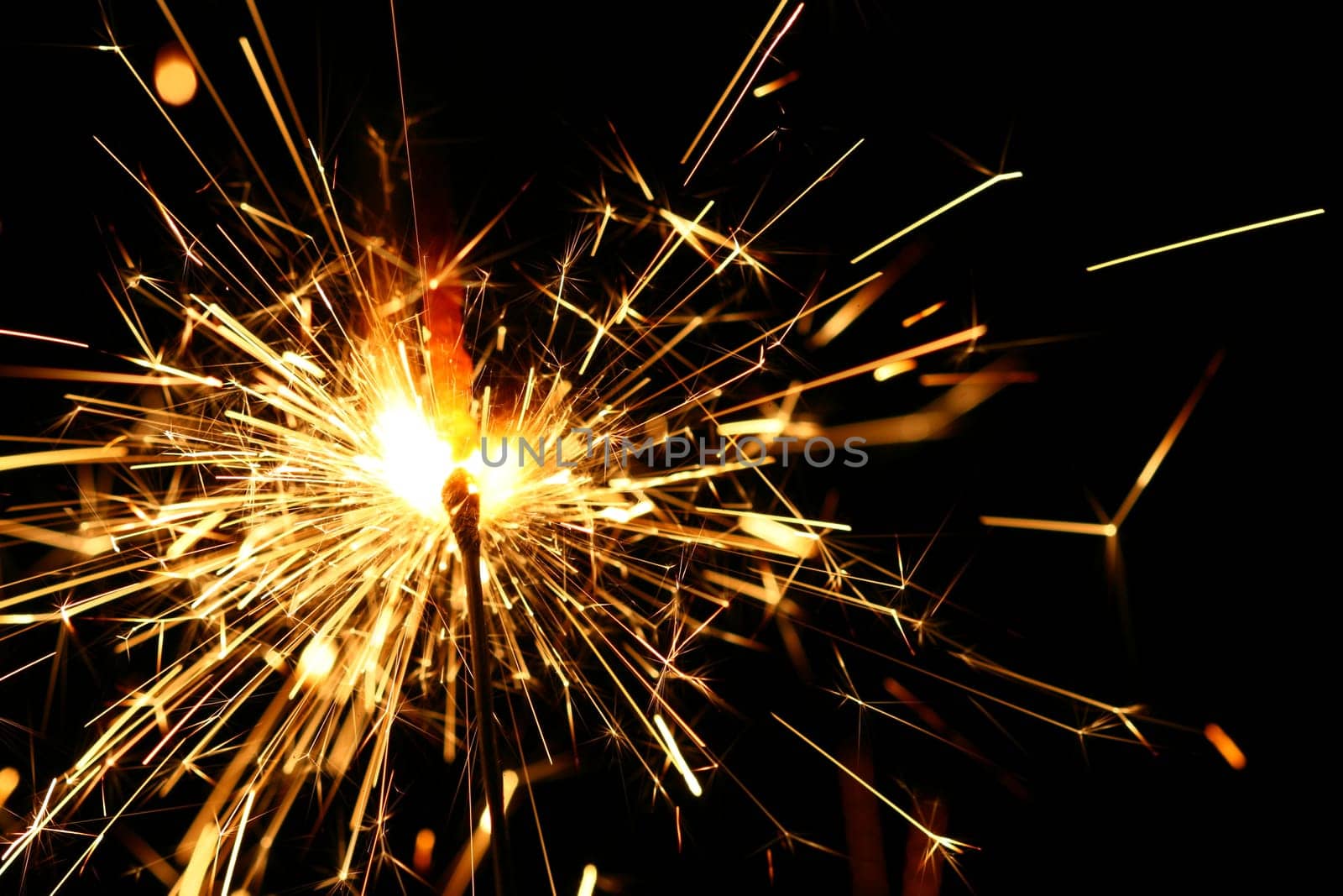 yellow sparkler holiday background on black