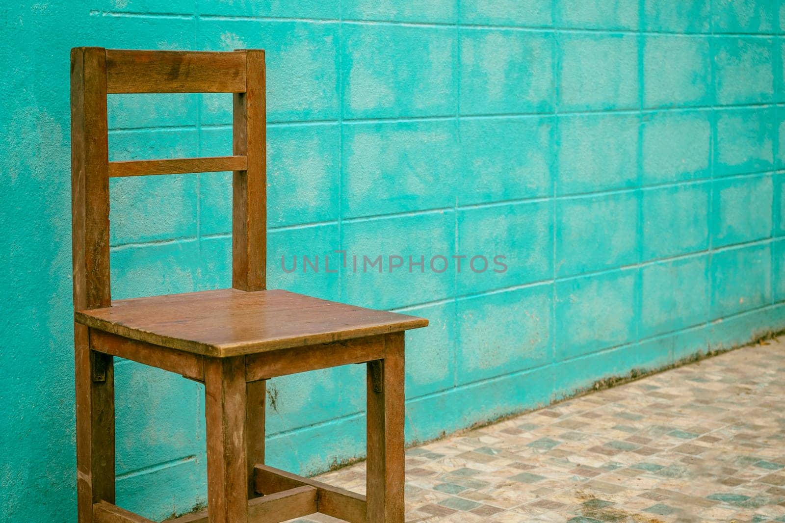 Old wooden chair on blue wall background