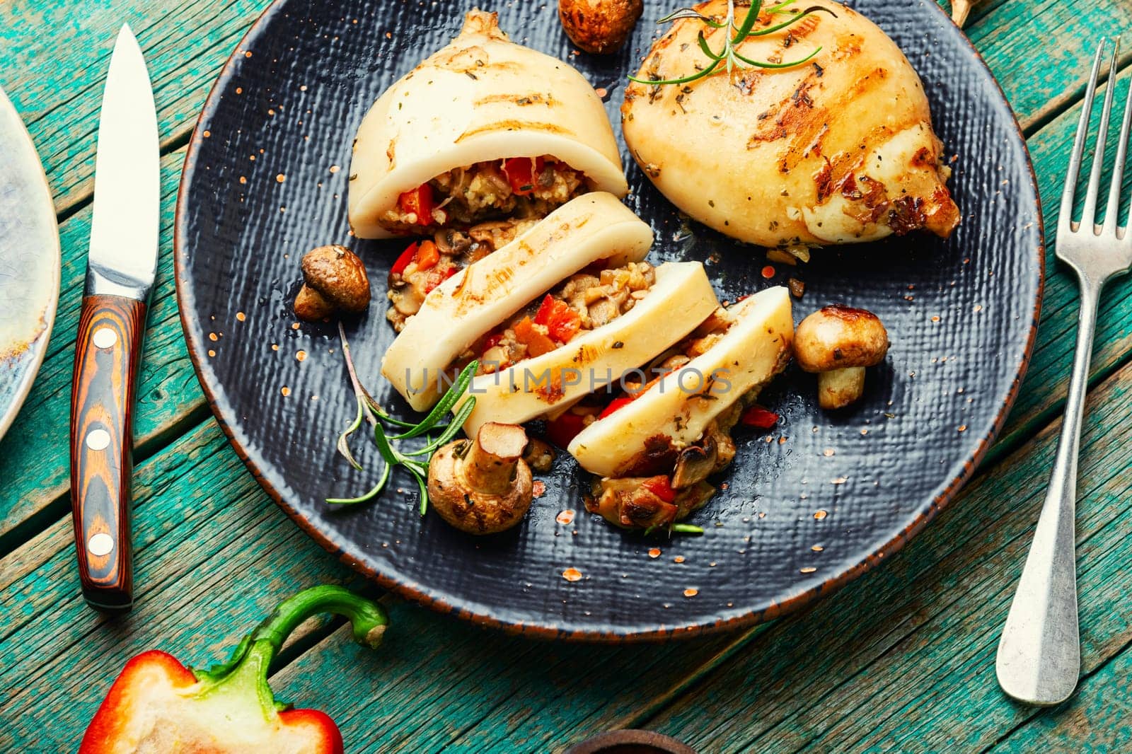 Grilled squids with vegetable stuffing. Stuffed calamari in grill pan