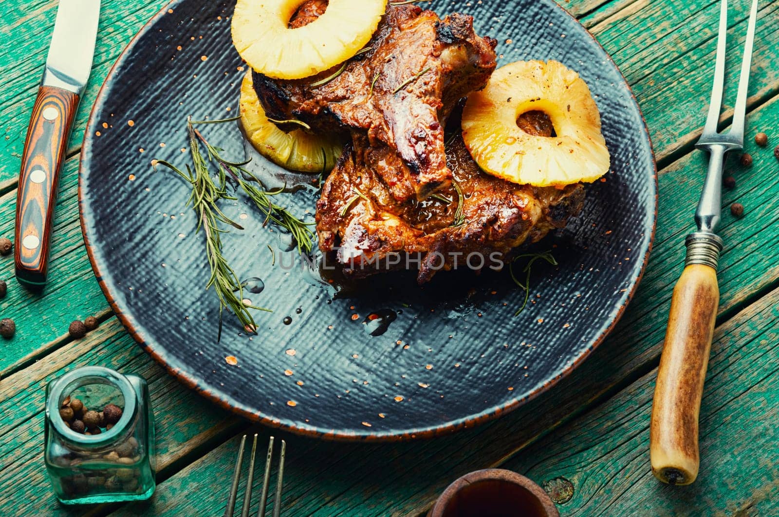 Grilled pork chop steak in pineapple syrup on the plate
