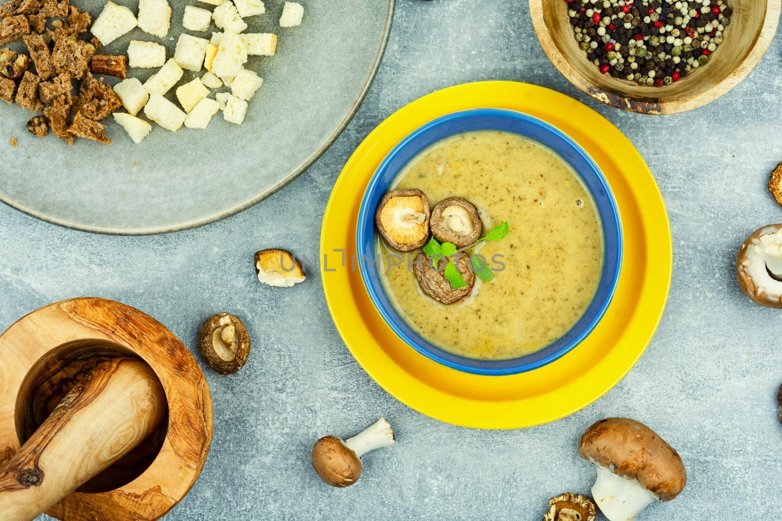 Tasty autumn soup on table. Yummy cream soup from champignon mushrooms.