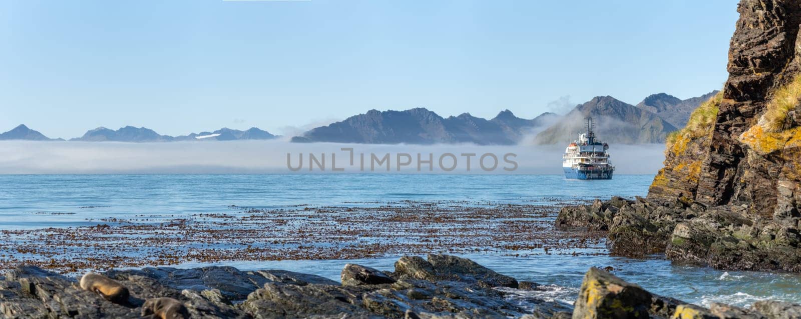 An Antarctic expedition ship lies at anchor off the coast of South Georgia - Widescreen Panorama