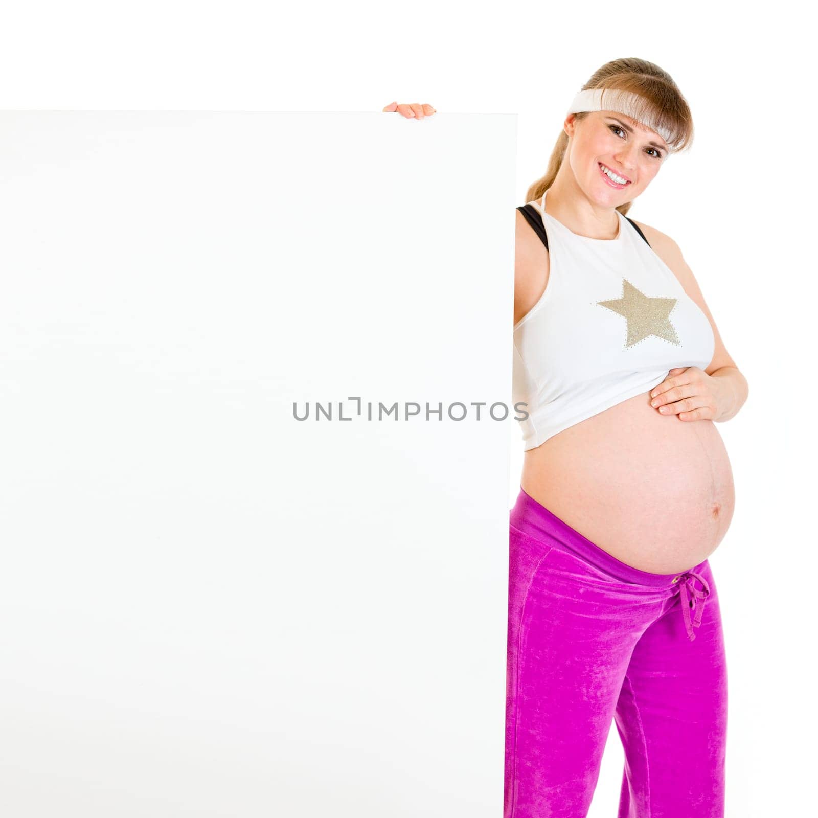 Smiling beautiful pregnant female holding blank billboard  isolated on white.