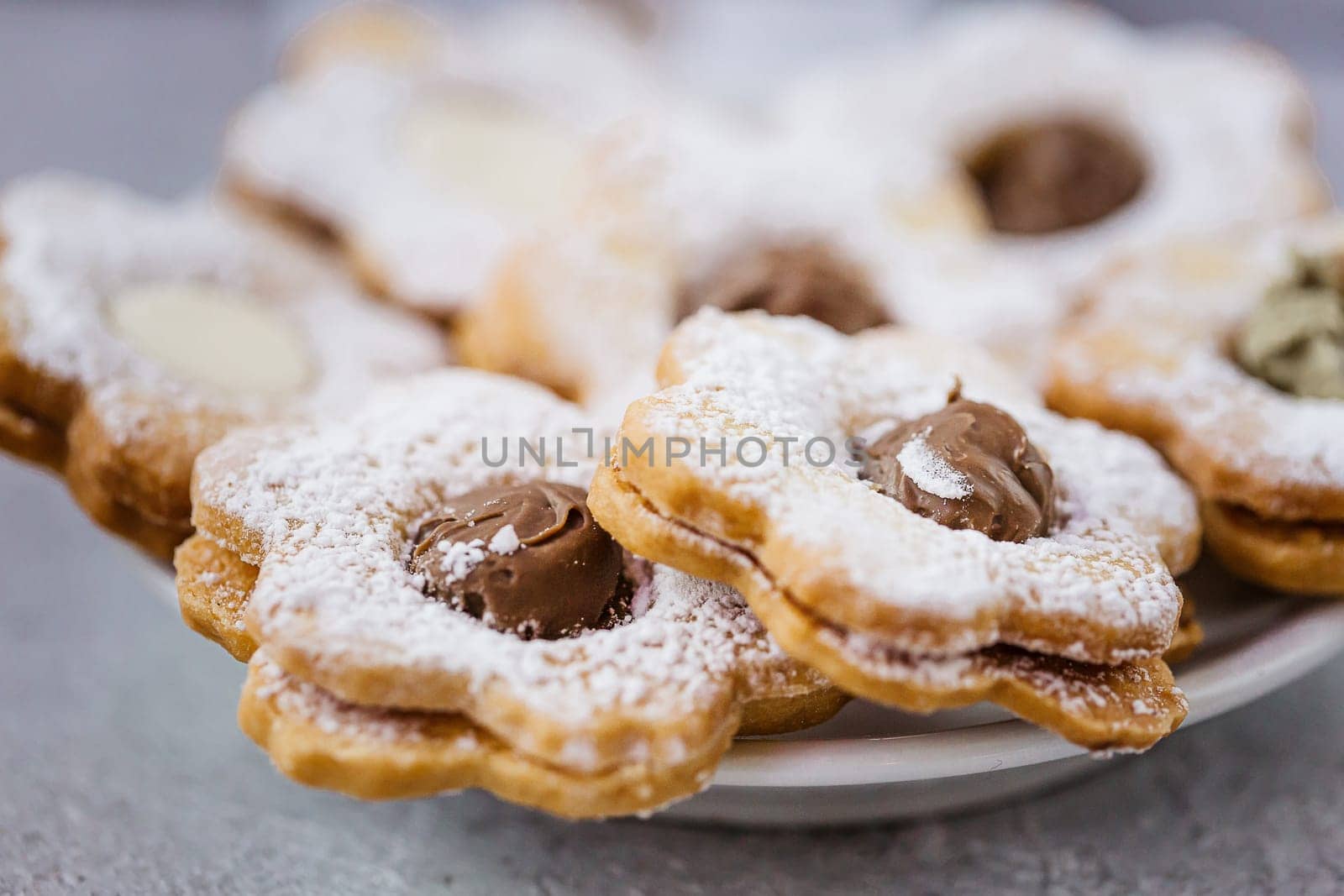 Tasty traditional homemade gingerbread Christmas cookies on grey. Close up view. Space for text.