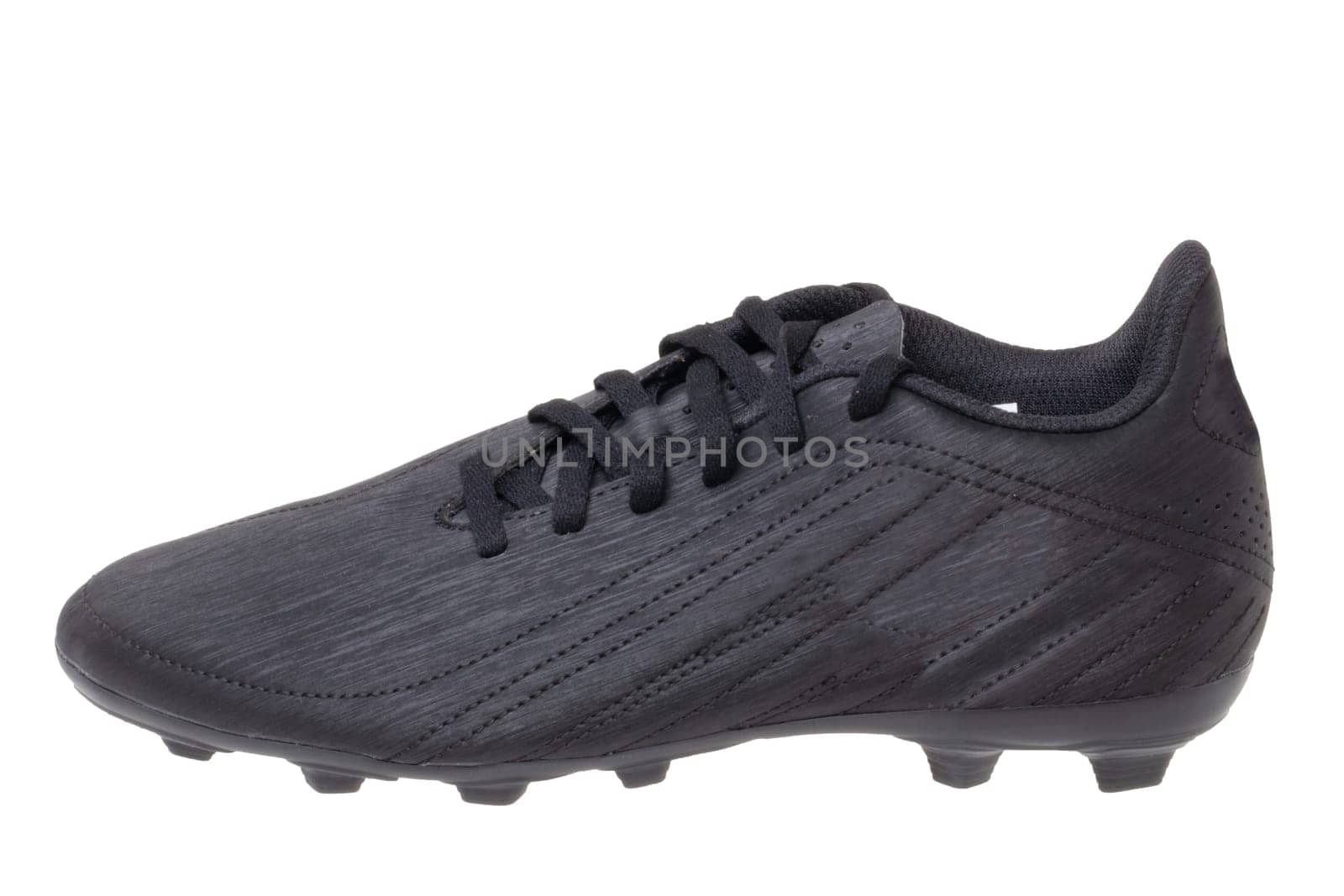 Closeup of a single black leather football boot isolated on white background. Professional athletics boys outdoor training shoes. Sports shoes.