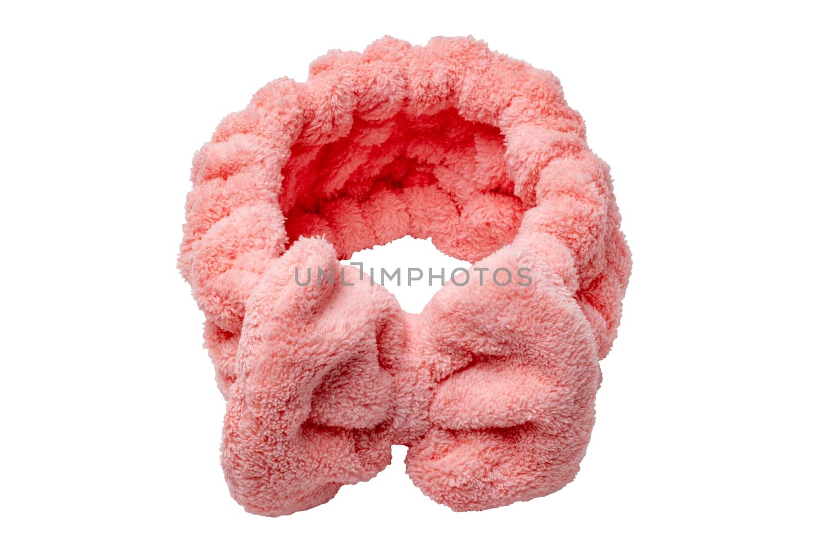 Pink hair band made of high quality coral fleece which is super soft and skin friendly. Hairband for face wash, make-up, shower, skin and beauty care for ladies and girls isolated.